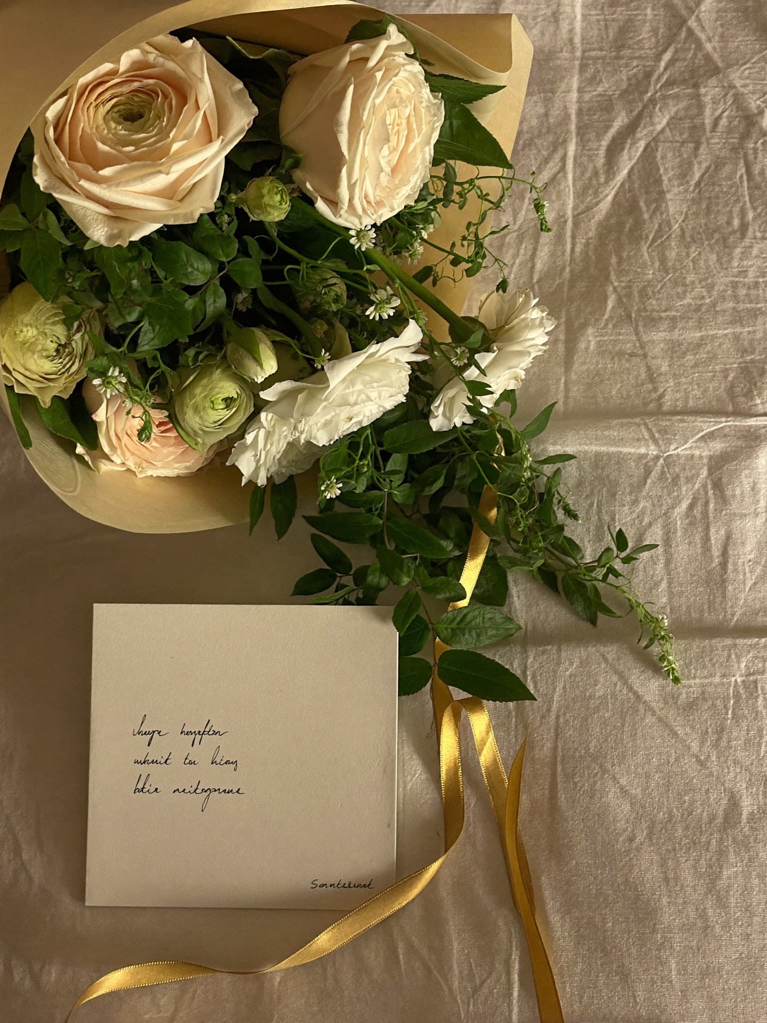 A wedding bouquet of garden flowers resting on linen